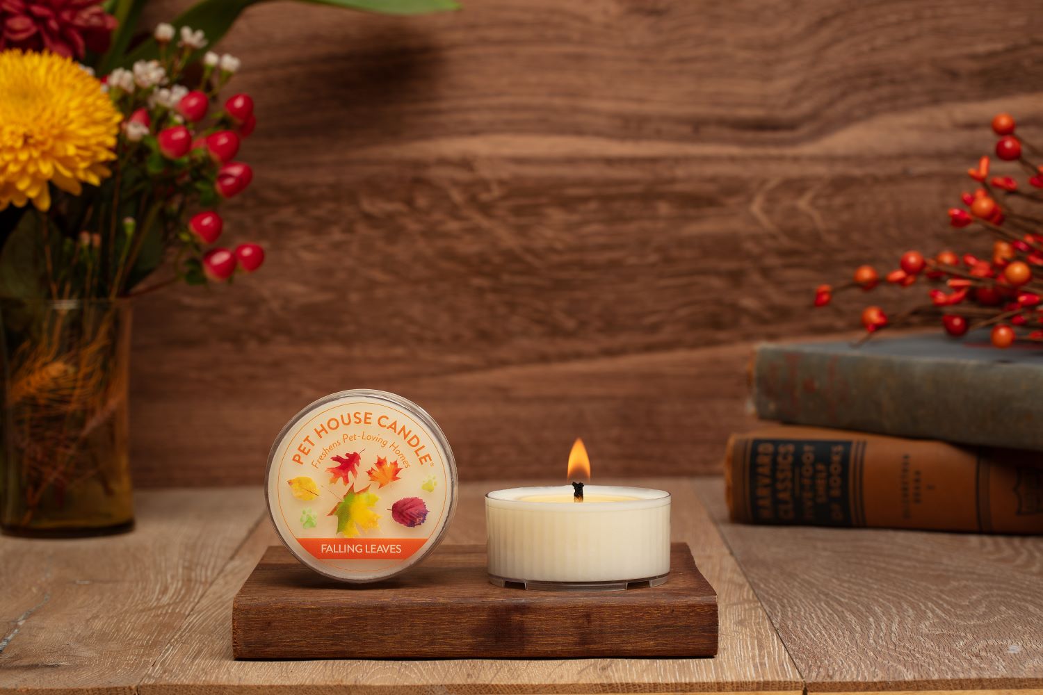 Falling Leaves mini candle on top of a small wood