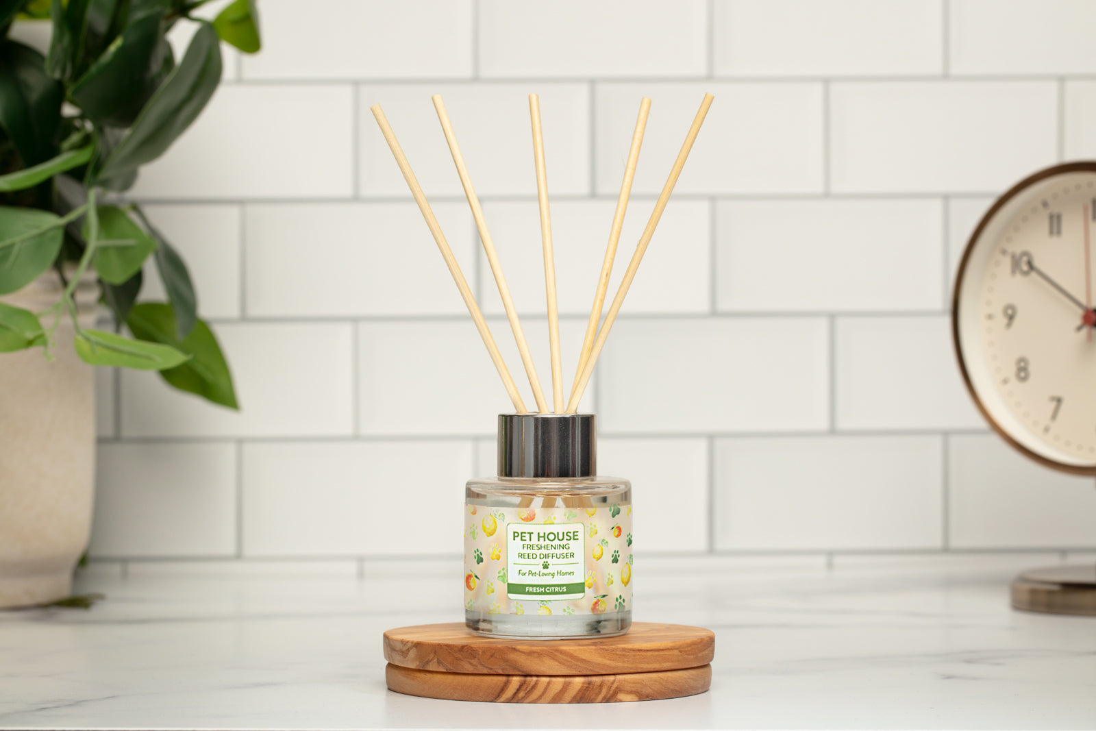 Fresh Citrus Reed Diffuser on top of a wooden coaster