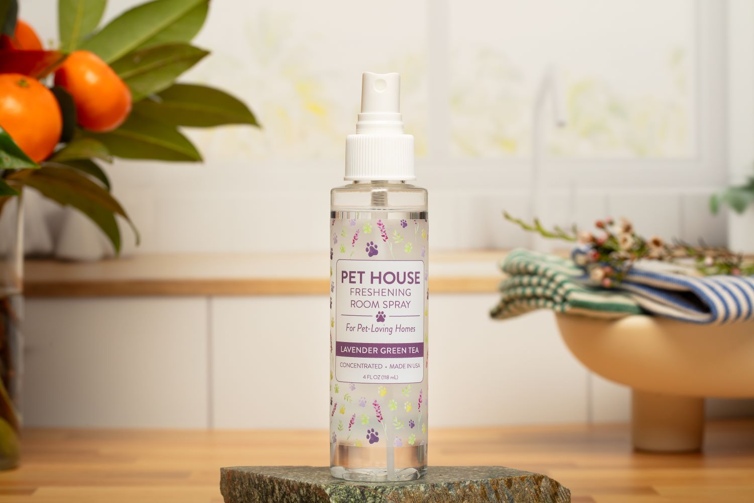 Lavender Green Tea Room Spray on a small stone